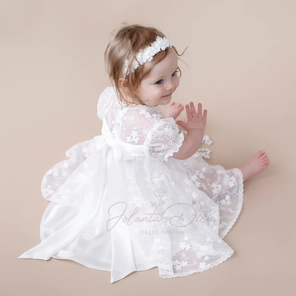 Baby girl in a white christening gown