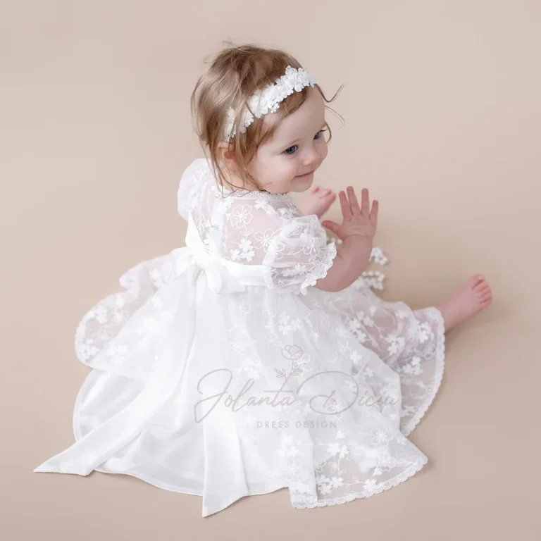 Baby girl in a white christening gown