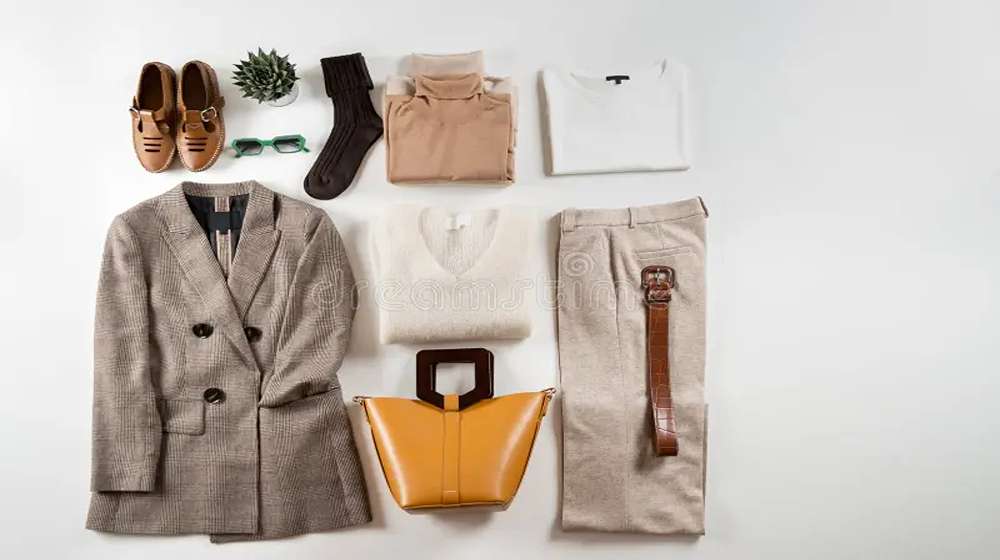Flat lay of a 30 piece capsule wardrobe: tops, bottoms, layers, shoes and accessories