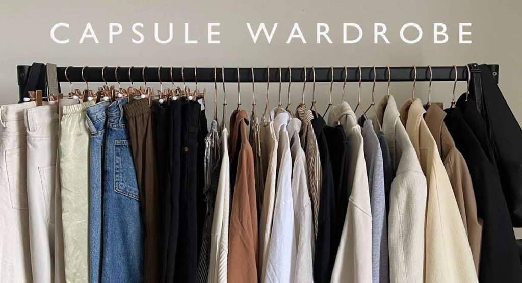 Flat lay of a 25 piece capsule wardrobe checklist, tops, bottoms, layers, shoes, accessories,