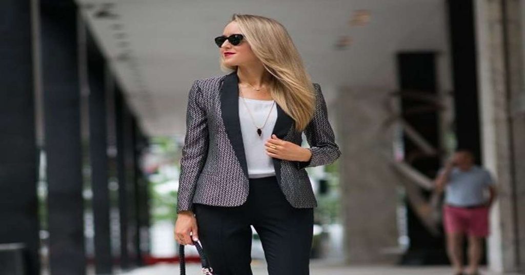 Smart casual work outfit with a blazer over a knit top and tailored trousers