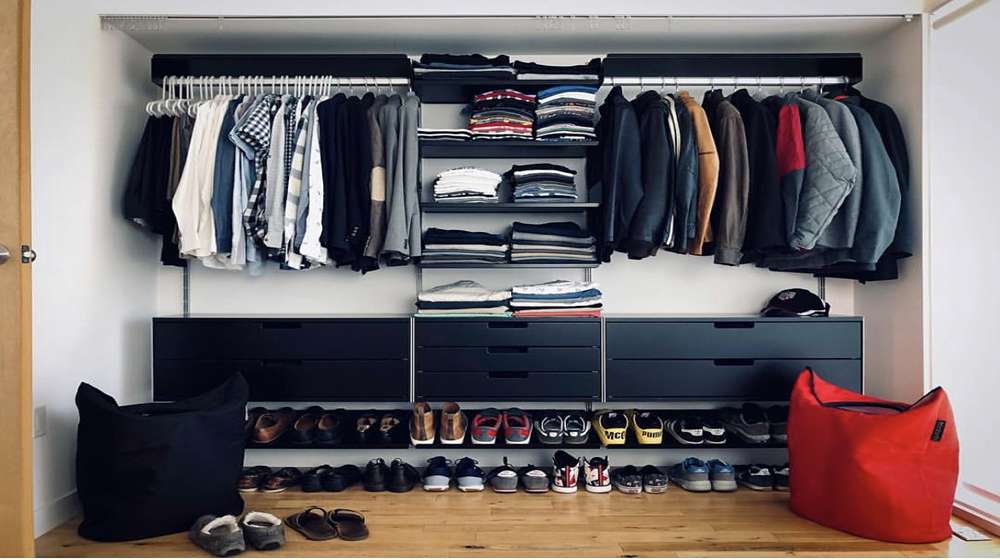 Finished capsule wardrobe for men hanging in an organized closet